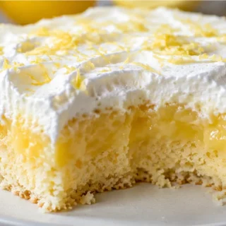 Zesty Keto Lemon Poke Cake - keto lemon cake - Keto Lemon Cake: whip up this vibrant and guilt-free poke cake, infused with a tangy sugar-free lemon curd. Perfe